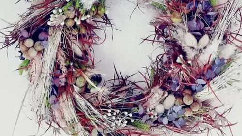 Colorful floral wreath against white background.