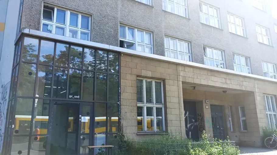 Modern building facade with glass entrance.