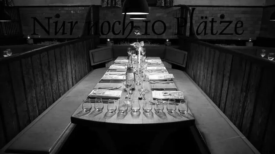 Elegant dining table set in dimly lit restaurant.