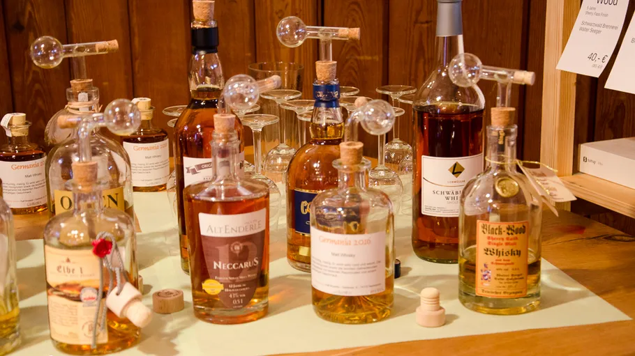 Various whiskey bottles displayed on a table.