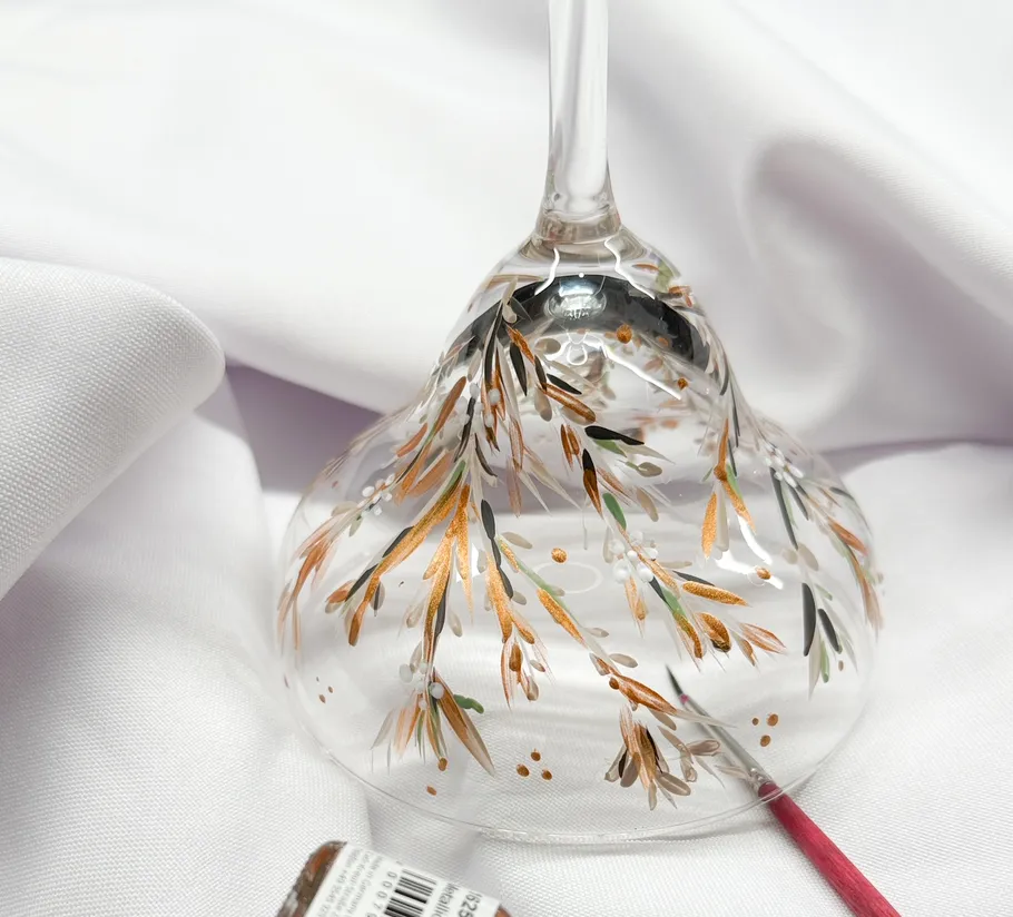 Decorated glass base with floral pattern on cloth.