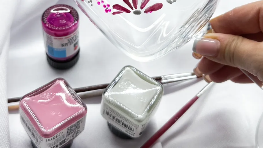 Hand painting glass with floral design.