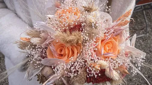 Orange flowers held with delicate white accents.