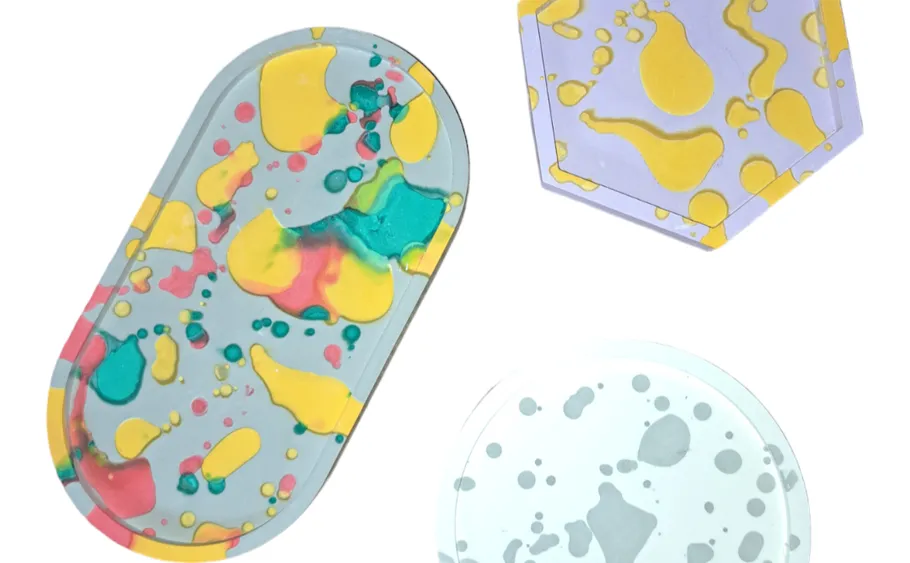 Colorful resin trays with abstract patterns.