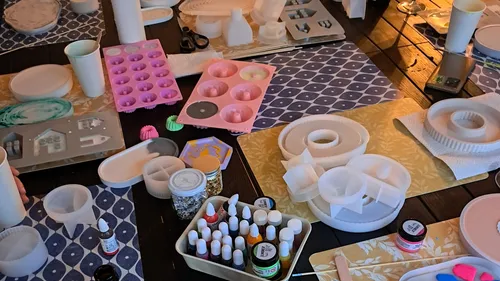 Craft table with molds and resin supplies.