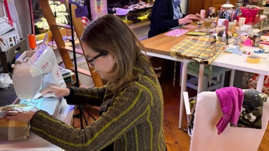 Woman sewing in a craft room.