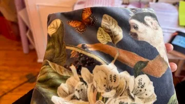Fabric with monkey, flowers, butterfly pattern.