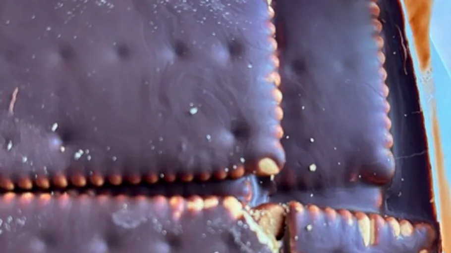 Chocolate-covered biscuits in a container.