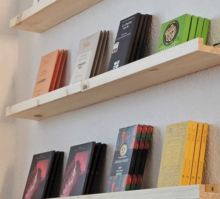 Chocolate bars displayed on wooden shelves.