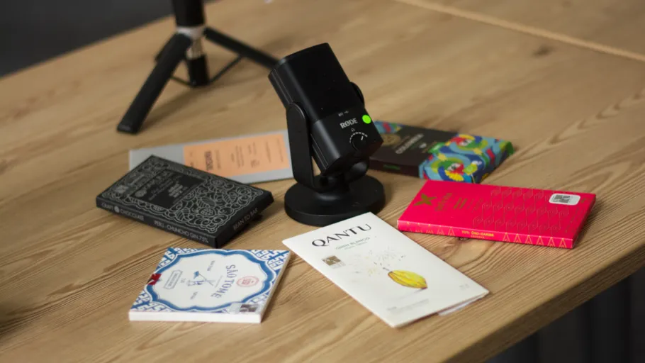 Microphone on desk with chocolate bars around.