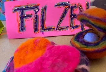Colorful felt with decorated 'Filzen' sign.