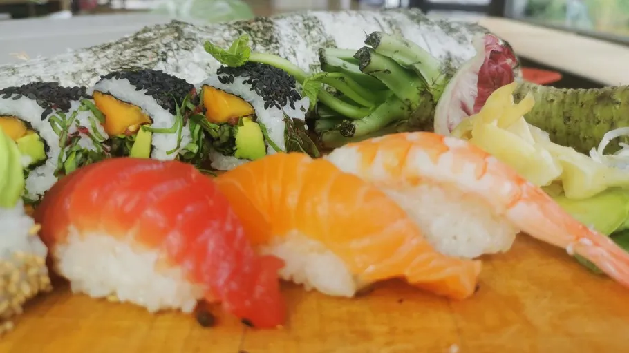 Sushi platter with nigiri and rolls displayed.