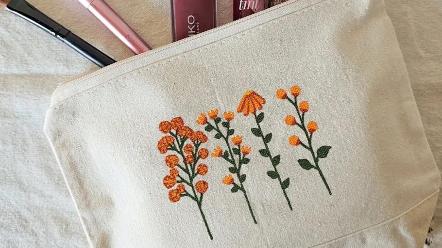 Makeup bag with floral embroidery design.