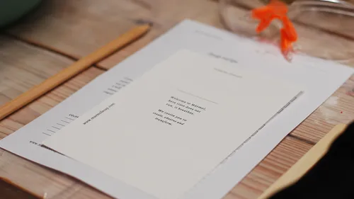 Papers and pencil on wooden table.