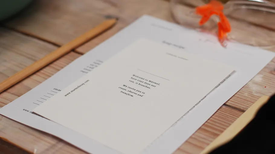 Papers and pencil on wooden table.