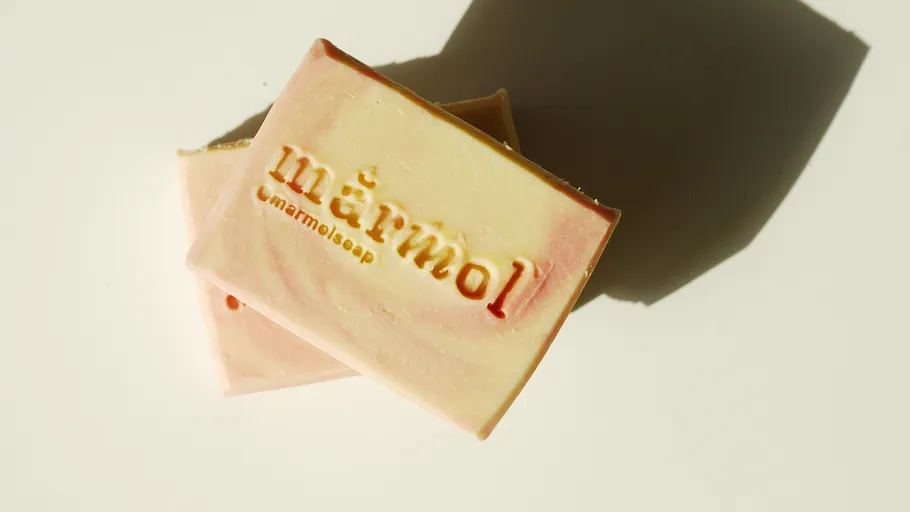 Two soap bars with embossed text.