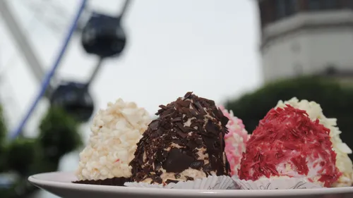 Desserts with chocolate and cream toppings outside.