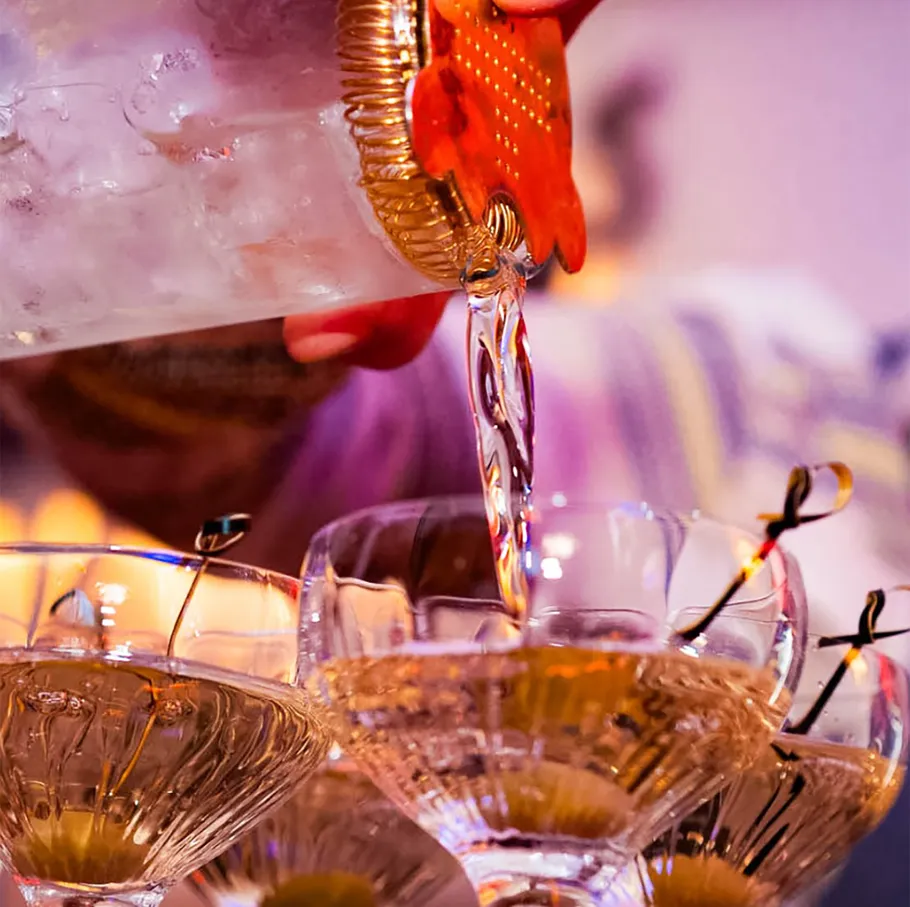 Cocktail being poured into glasses.