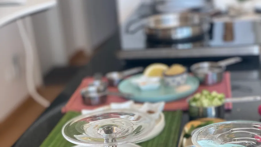 Blurred kitchen scene with utensils and ingredients.