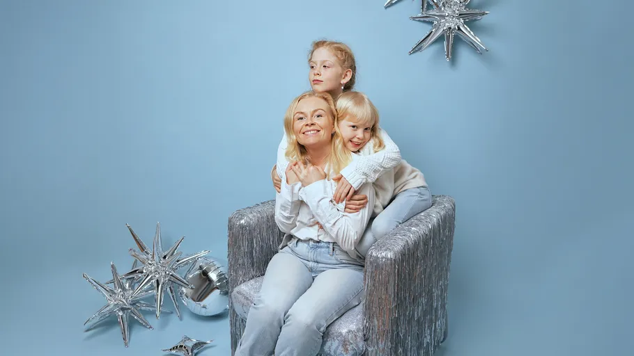 Three people sitting in a festive setting.