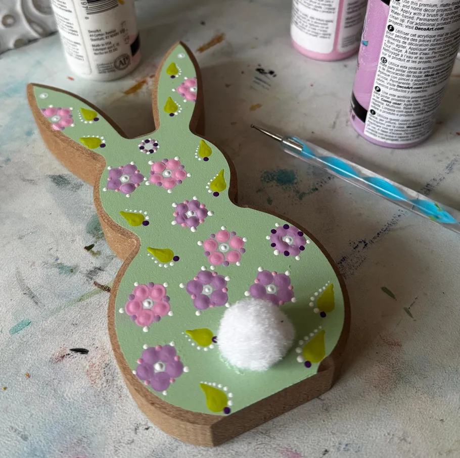Painted wooden bunny with floral design.