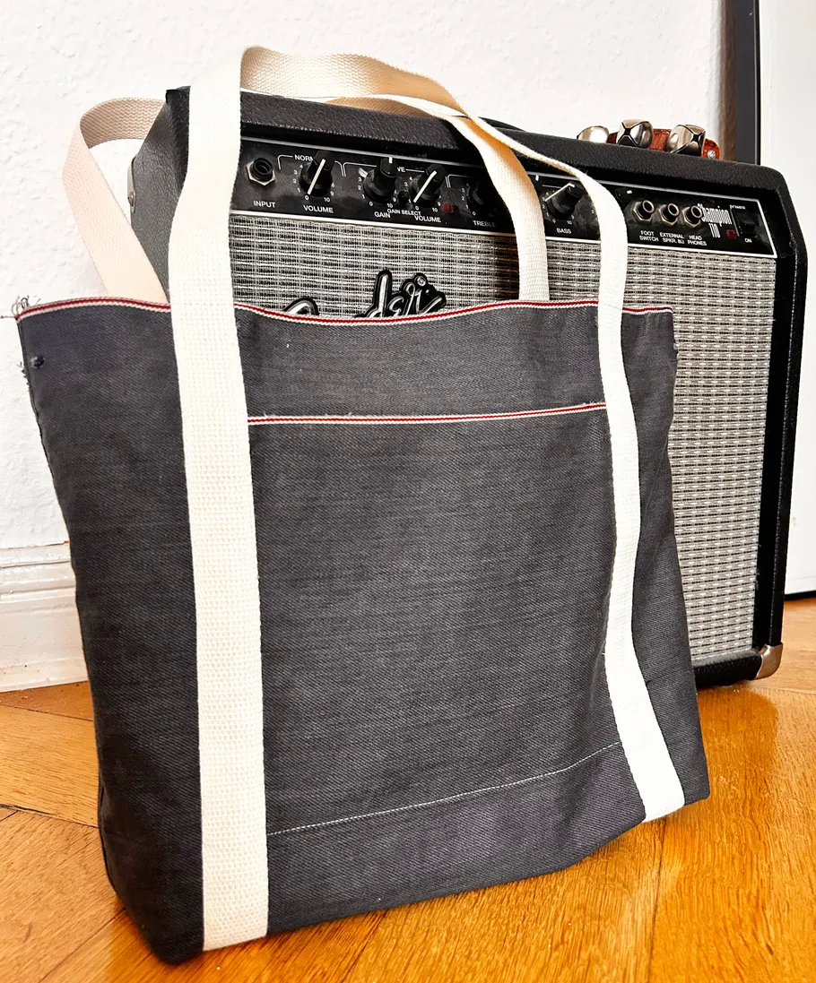 Tote bag leaning against guitar amplifier.
