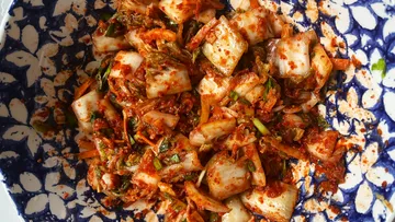 Kimchi in a blue-patterned bowl.