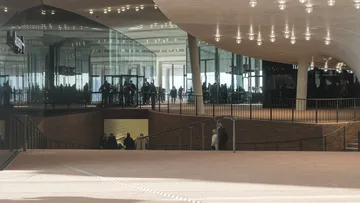Modern architectural interior with people walking.