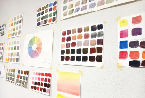 Paint swatches and color wheel on wall.