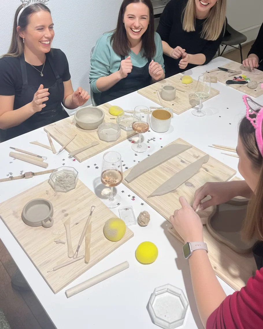 Group of women laughing during pottery class.