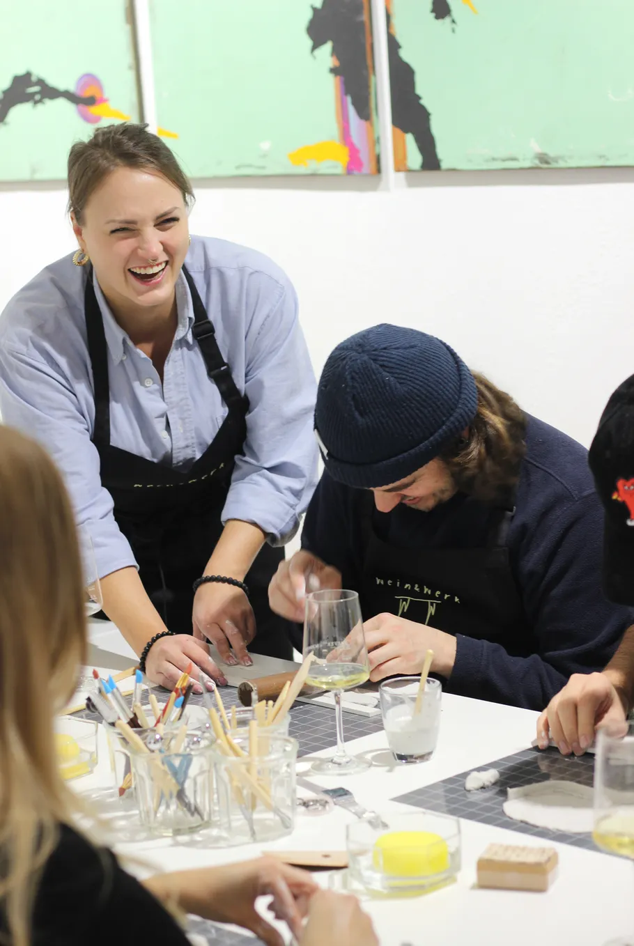 People happily engaging in a pottery workshop.