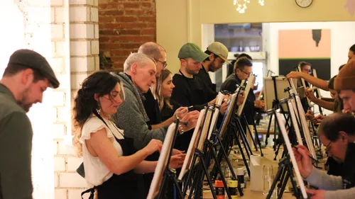 Group painting on easels in a studio.