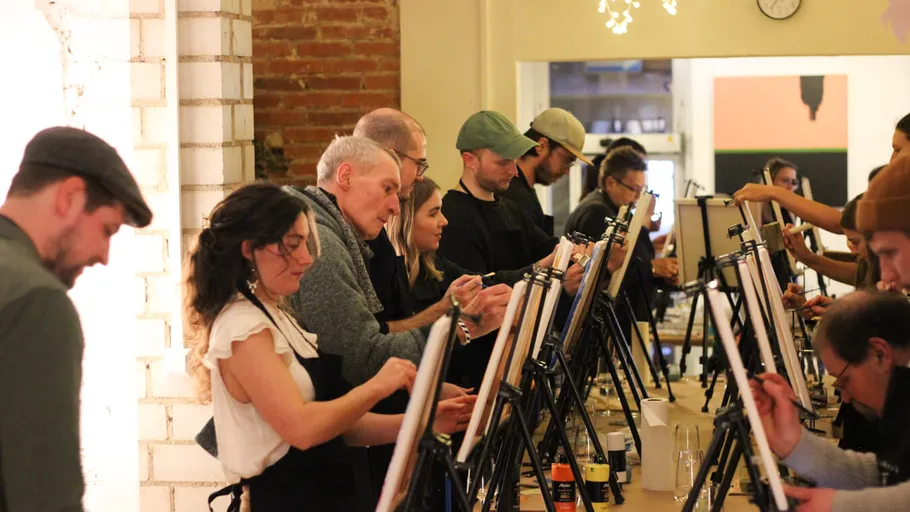 Group painting on easels in a studio.