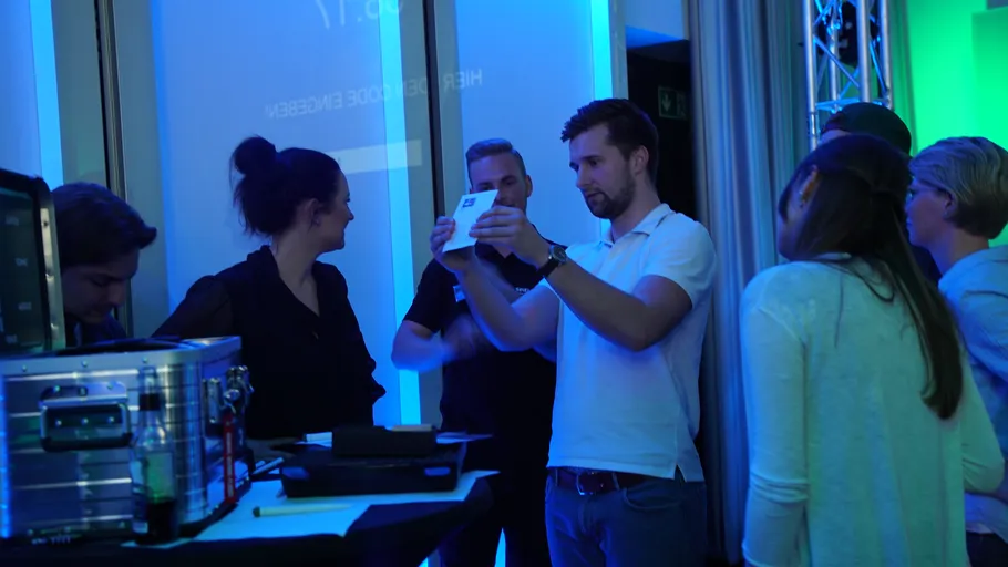 Group in office setting, using technology.