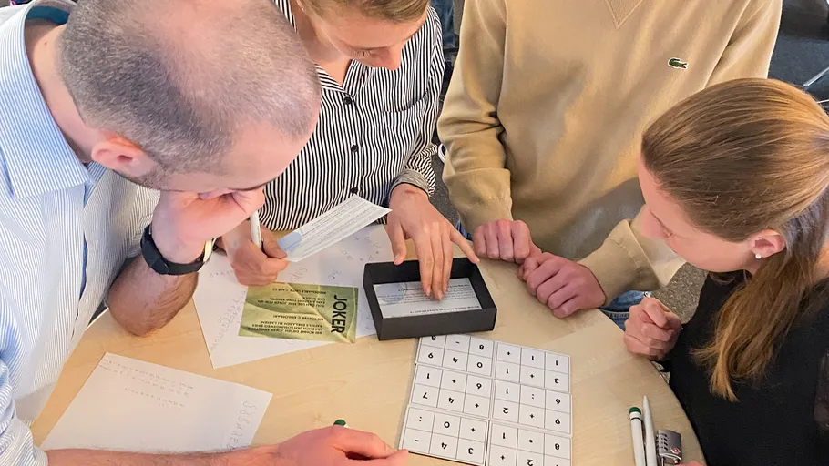 People solving puzzle at a table.