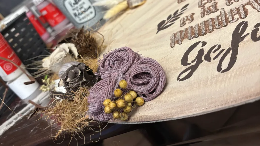 Decorative item with text on wooden surface.