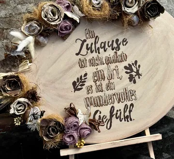 Decorative wooden plaque with floral embroidery.
