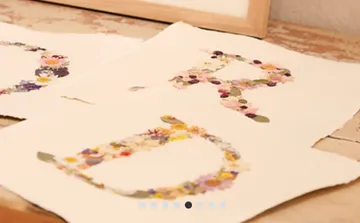 Floral letters on rustic paper sheets.