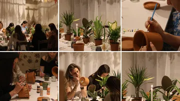 Menschen bemalen Keramik in gemütlicher Werkstatt.
