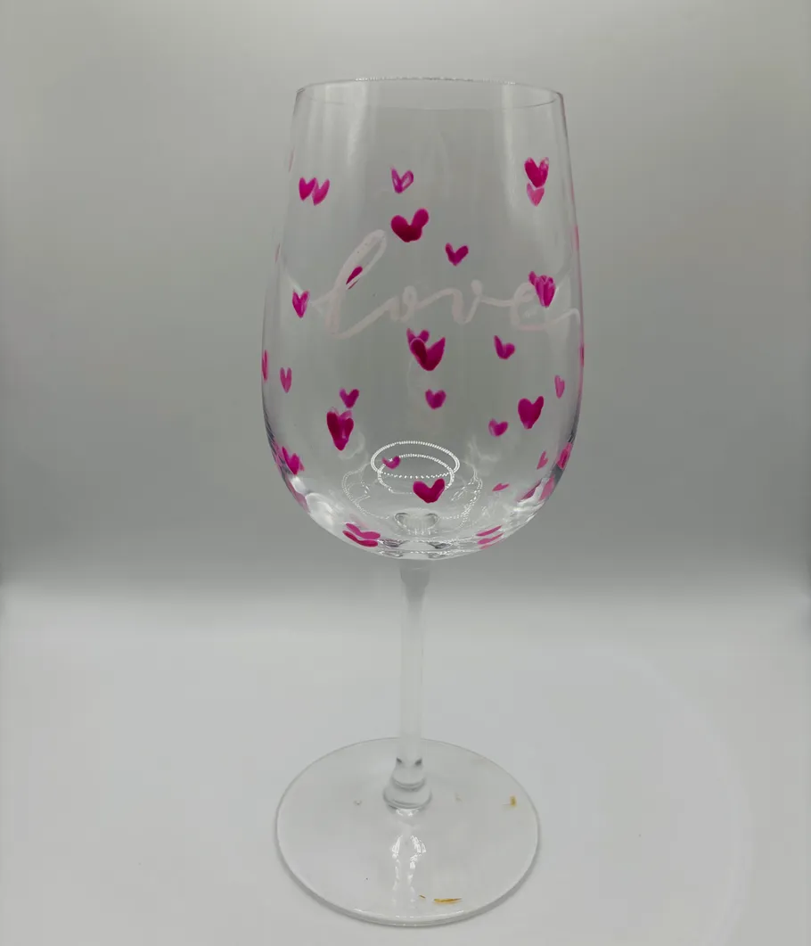Wine glass with pink heart design.