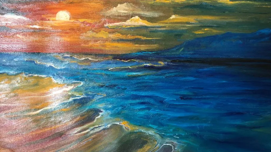 Sunset over ocean with colorful waves.