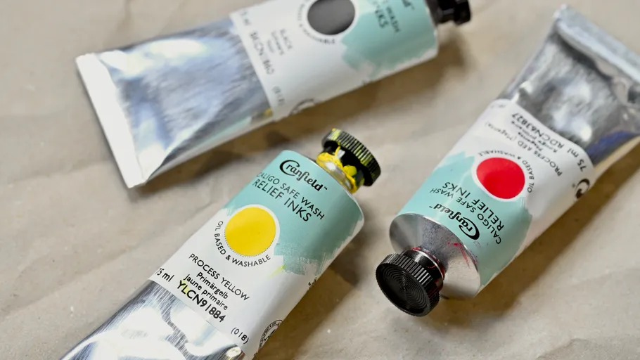 Three tubes of printing ink on a table.