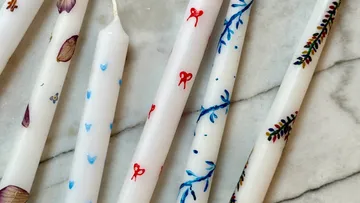 Decorated candles on a marble surface.