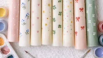 Painted candles with floral and geometric designs.