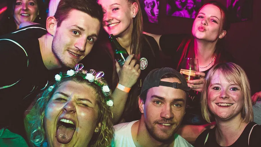 Group of friends smiling at a party.