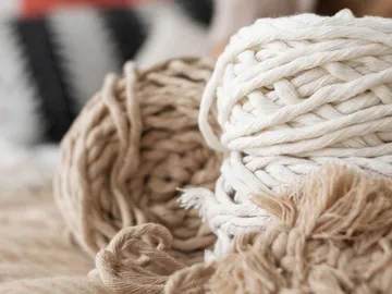 Wool lies loose on a soft surface.