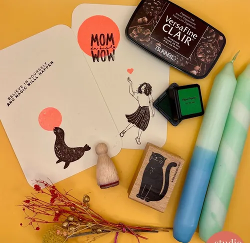 Craft supplies and cards on yellow background.