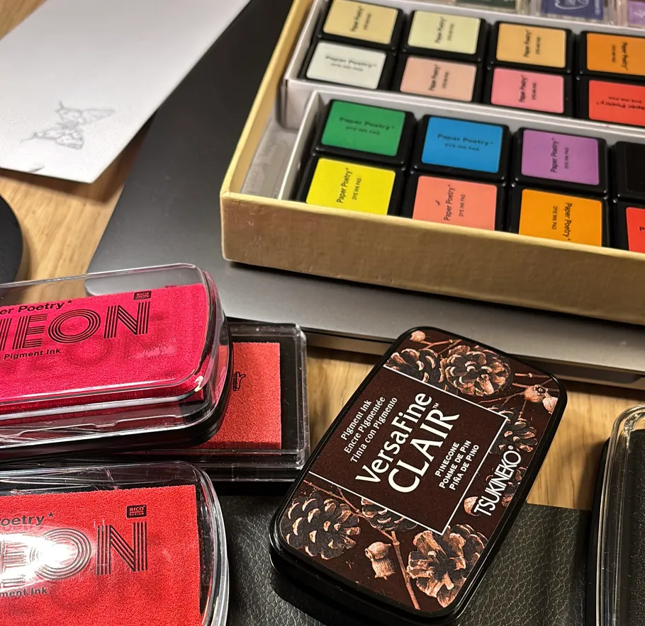Colorful ink pads on wooden table.