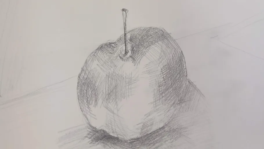 Pencil sketch of an apple on paper.