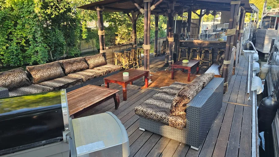 Outdoor seating with leopard-pattern cushions on a boat.